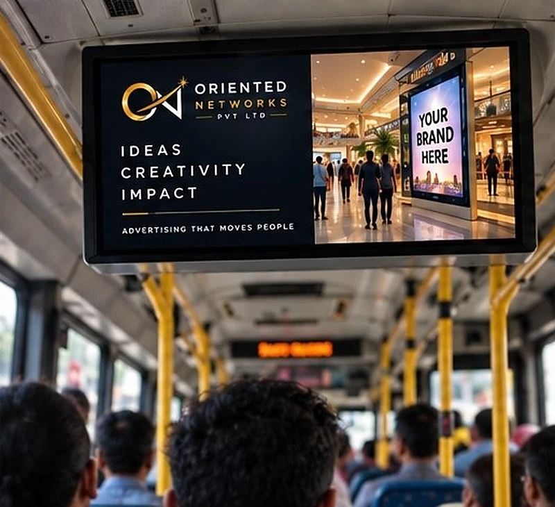 A ceiling-mounted HD screen fitted inside a bus, playing an Oriented Networks advertisement above the seats